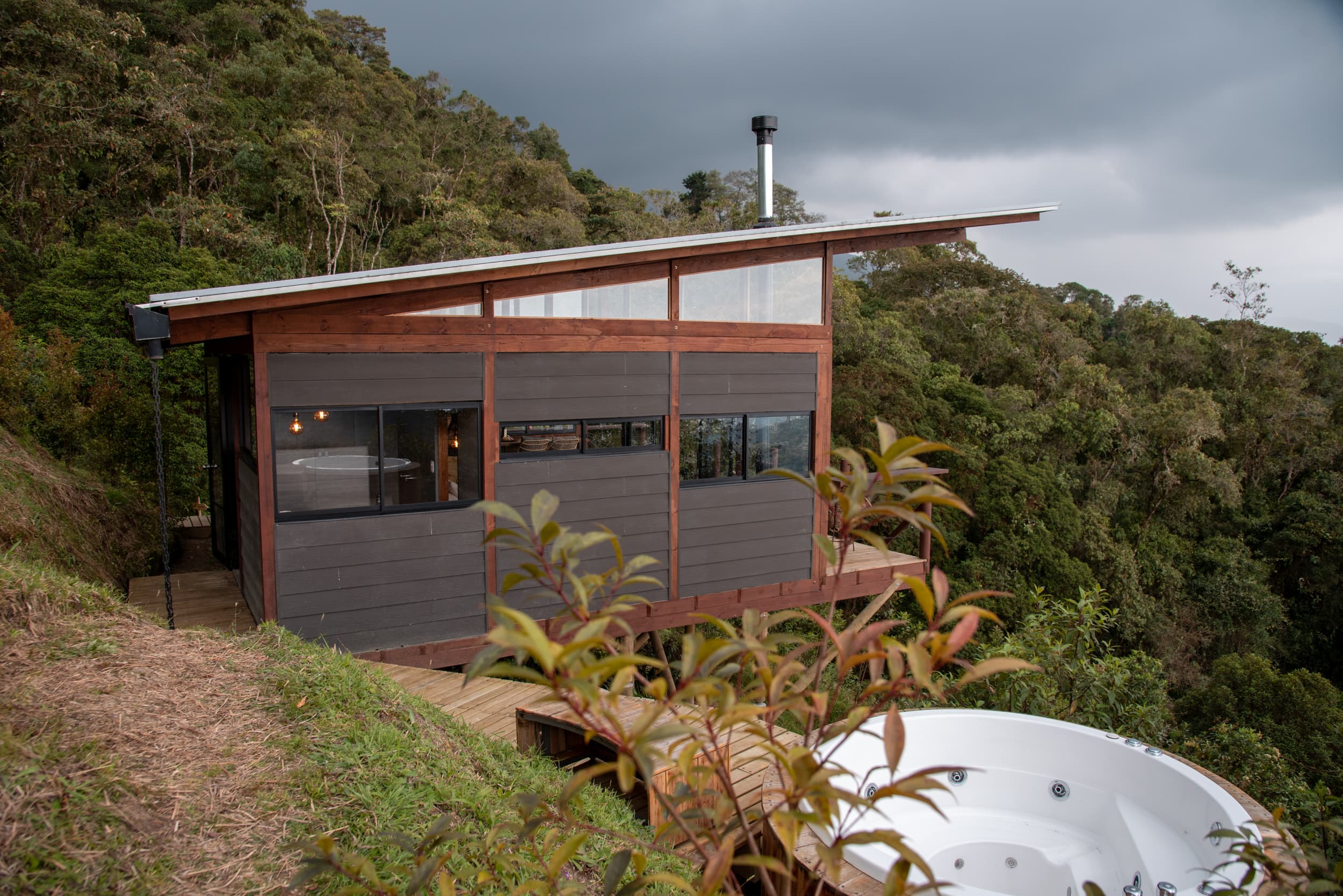 Cabin exterior with jacuzzi and forest views